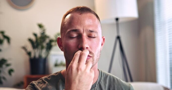 Breathe, relax and man with eft tapping on sofa for anxiety, mental health and holistic healing. Psychology, calm and male person with spiritual energy for reiki treatment, therapy or zen in home