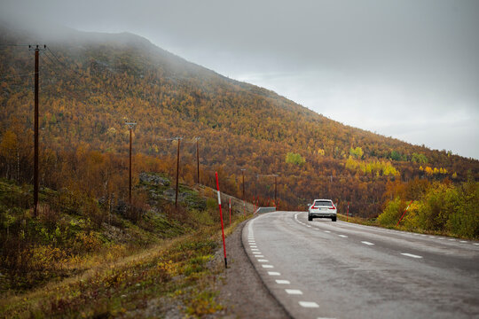 Scenic view of car moving on road overlooking mountain against sky