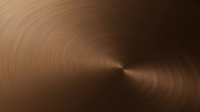 Slow motion closeup of rotating brushed bronze metal surface with circular swirl pattern under studio lighting