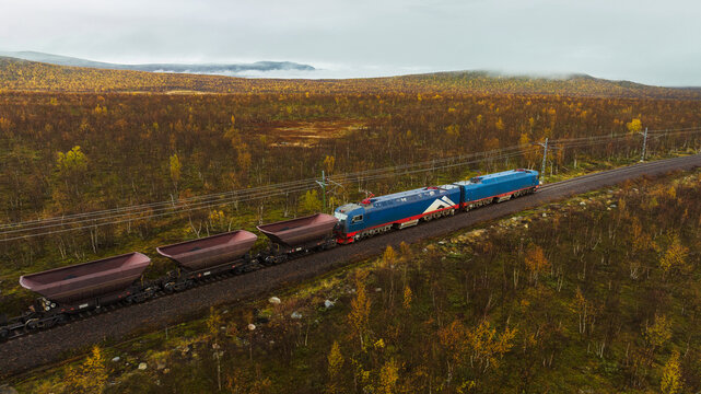 Drone view of train shipping coal while moving on track