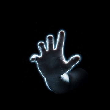 A glowing hand reaching out in darkness with neon blue light outline.