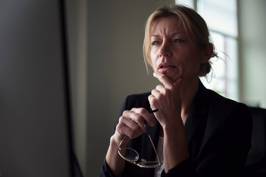 Confused female business expert working in tech office