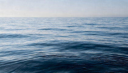 Fototapeta premium Calm Horizon: Expansive Blue Ocean Water Texture Under Clear Sky