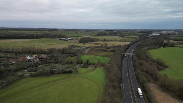 Wide aerial view of Twywell village and A14 road with Northamptonshire countryside Northamptonshire England