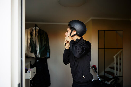 Boy wearing helmet before leaving from home