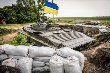 Obraz premium BMP-2 infantry fighting vehicle on checkpoint of Armed Forces of Ukraine near Dobropillia during War in Donbas, Ukraine