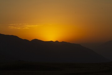 Fototapeta premium Sunset Over Mountainous Terrain