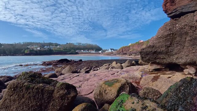 Seascape of Dunmore East Village Waterford Ireland beautiful spring colours ebbing waves and blue skies before the tourist season