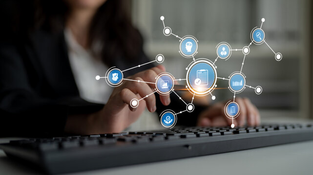 A business professional interacts with a keyboard, surrounded by digital icons symbolizing data analysis and technology, emphasizing modern productivity and innovation. Tessel