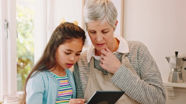 Grandmother, girl and tablet in kitchen with search for recipe, helping hand and guide with cooking in home. People, grandma and child with tech, application or tutorial for bonding at family house