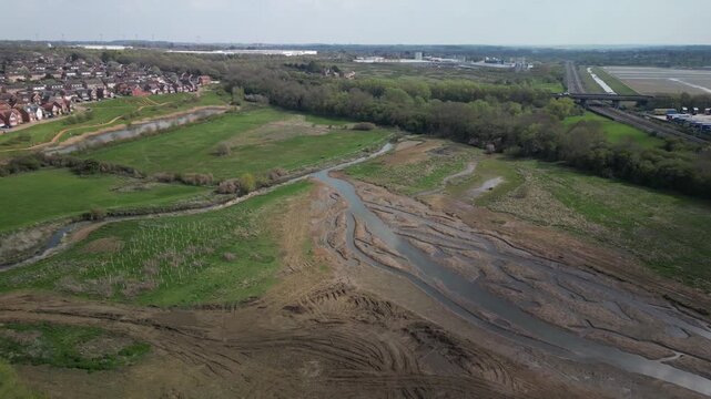 Aerial drone flight over dried lake bed with mud patterns and channels at Barton Seagrave Northamptonshire