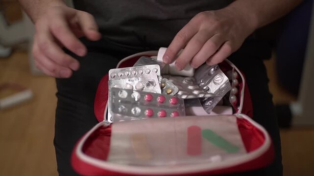 First aid kit. Man. Medication pills. Slow motion video. . High quality 4k footage