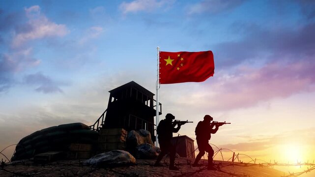 Chinese soldiers standing guard over a border post at sunset with a flag