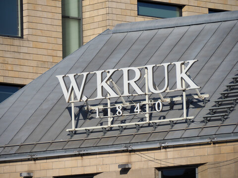 W. Kruk jewelry store signage with a crown logo on a dark rooftop