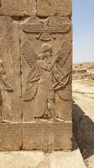 Obraz premium Ancient Persian Relief Sculpture Ancient Persian Relief Sculpture Winged Figure Archaeology Historical. Concept featuring ancient, persian, relief, sculpture, winged figure for professional commerc...