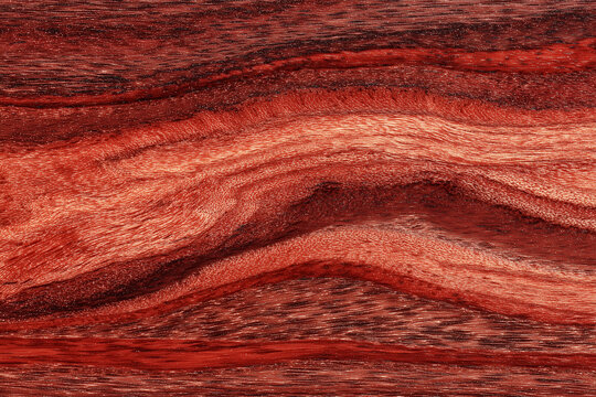A close up of bubinga wood grain showing the deep red color and natural pattern.