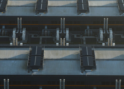 Aerial view of a data center facility with multiple cooling units and ventilation systems on its large roof, Middenmeer, Netherlands.