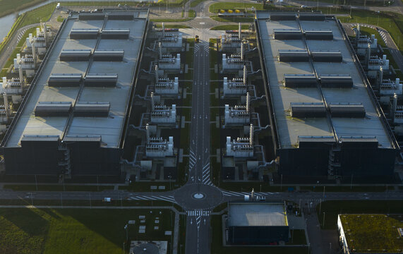 Aerial view of data center complex showcasing symmetrical architecture and infrastructure from an aerial perspective, symbolizing global connectivity, Middenmeer, Netherlands.
