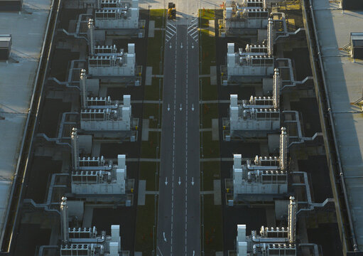 Aerial view of rows of industrial cooling systems and generators providing essential infrastructure for ai data processing and computational power, Middenmeer, Netherlands.