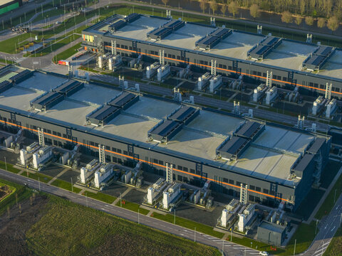 Aerial view of large data center ai campus featuring multiple buildings with advanced cooling units, representing modern cloud computing and internet infrastructure, Middenmeer, Netherlands.