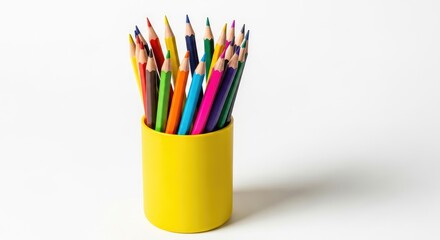 Fototapeta premium Collection of Vibrant Colored Pencils in a Yellow Cup Isolated on White Background