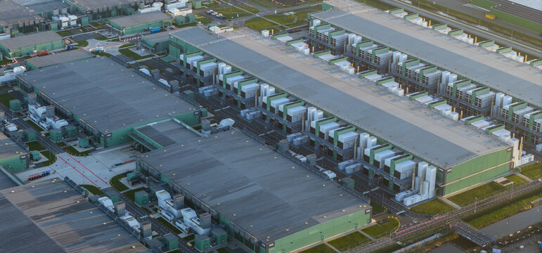Aerial view of large scale data center complex with multiple buildings, representing global communication, cloud computing, and digital growth infrastructure, Middenmeer, Netherlands.