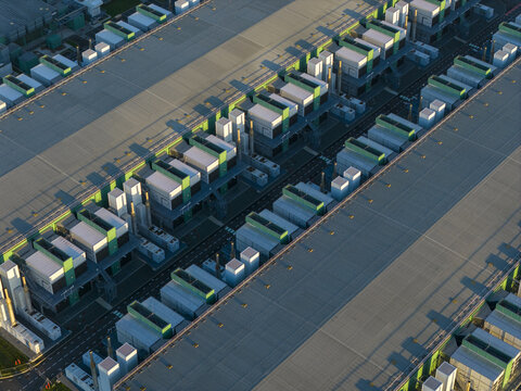 Aerial view of large computing facility with many modules for data processing and storage. Long shadows defining the complex geometry, Middenmeer, Netherlands.