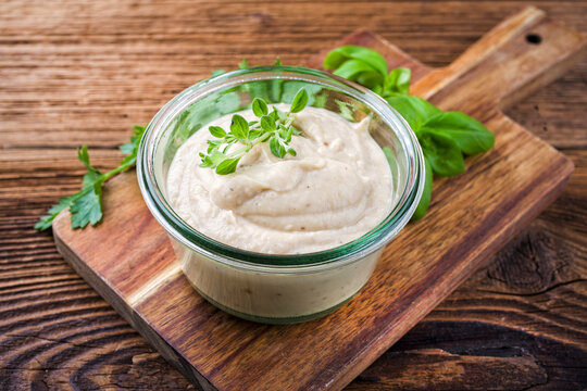 Traditional tuscan spicy Italian cannellini white bean dip spread served as close-up in a small jar