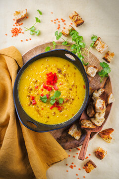 Traditional Indian style dal lentil soup Dal tadka with roasted flatbread served as top view in a design pot