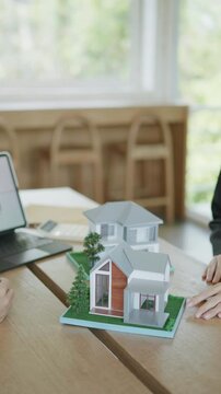 Discussing architectural models office setting presentation modern environment close-up view innovative design concepts