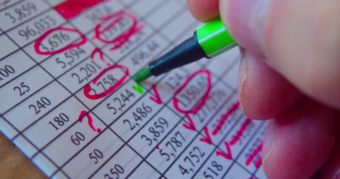 Paperwork.Close-up video of marker working with numbers on a paper sheet, illustrating business concept.