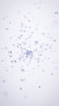 Abstract glass iridescent particles on a white background, vertical 4k seamless loop 3d animation