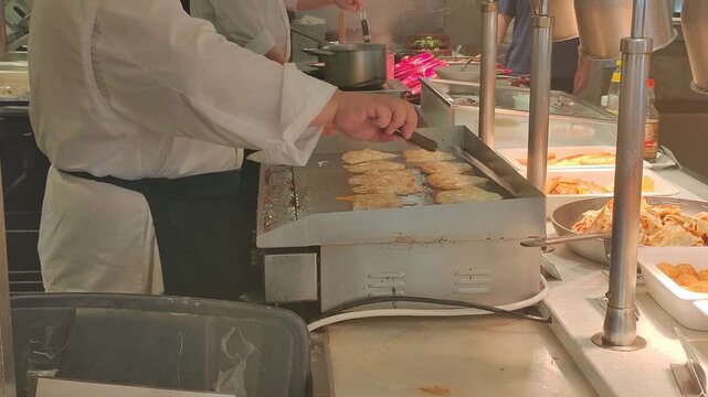 The chef is frying eggs