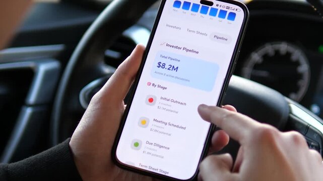 Venture Capital Investor Monitoring Series A Fundraising on Smartphone. Close-up of a mobile interface for startup investments. Visualizing fundraising goals, investor pipelines, and financial data. 