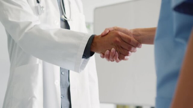 Doctor and patient shaking hands in a hospital setting showing trust and professional agreement