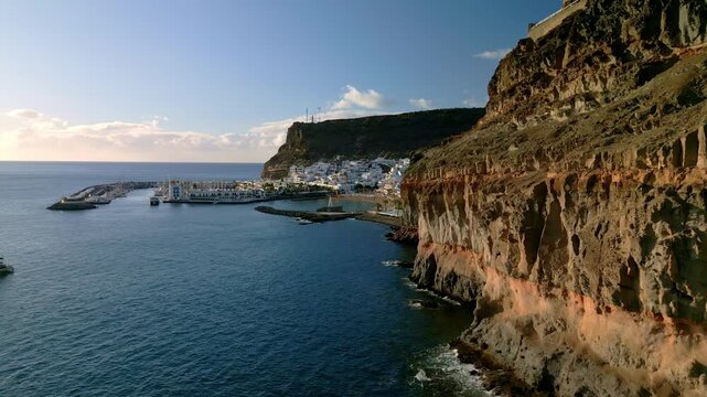 Aerial view of Playa de Mogan, harbor and colorful buildings in picturesque fishing old village Puerto de Mogan, Gran Canaria, Canary Islands, Spain