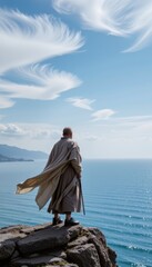 Fototapeta premium Stoic Samurai Monk-like Figure Poised on a Weathered Precipice, Gazing at the Majestic Sea of Japan Beneath a Cerulean Obon Sky