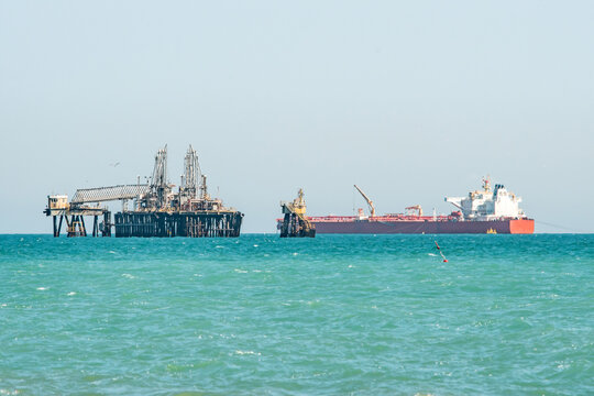 Transshipment of oil and petroleum products between an oil refinery and a tanker at a marine terminal in the Mediterranean at sea, logistics shipping. War Iran. Hormuz