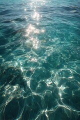 Fototapeta premium Sunlight dances on clear turquoise waters
