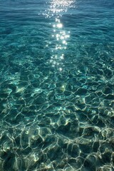 Obraz premium Sunlight dances across crystal-clear turquoise waters