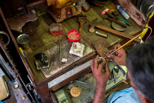 Artisan Goldsmith Handcrafting a Gold Bangle in Traditional Workshop