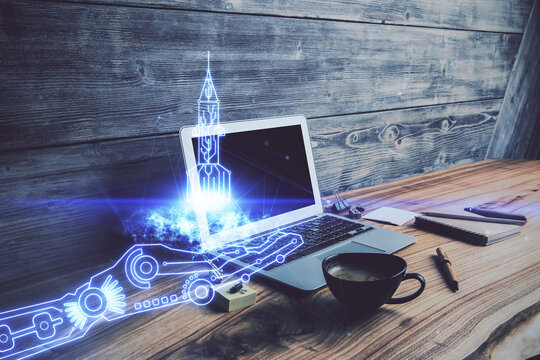 Desktop computer background in office and start up theme hologram drawing. Double exposure. Startup concept.