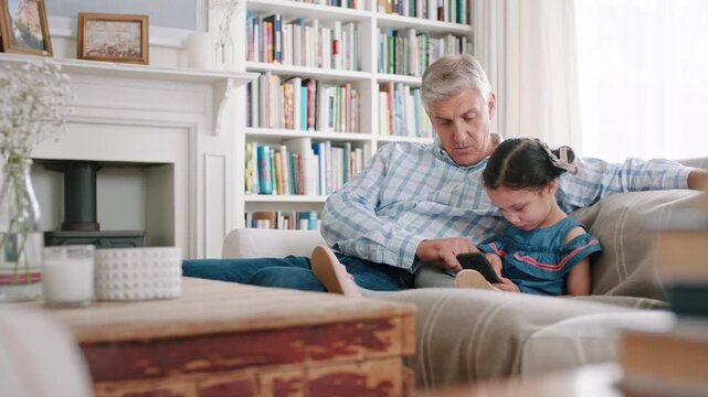Smartphone, relax and grandfather with child on sofa in home for social media, gaming or bonding. Talking, technology and senior man with girl kid on phone for online game on mobile app in house.