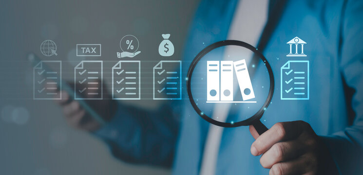 Financial audit concept, Budget, accounting review, business inspection, data verification, check income and expenses. Magnifying glass focusing on document file icon