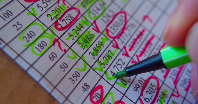 Paperwork.Close-up video of marker working with numbers on a paper sheet, illustrating business concept.