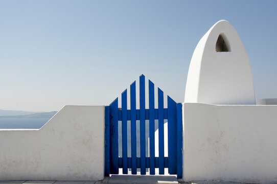 Blue gate and white wall.