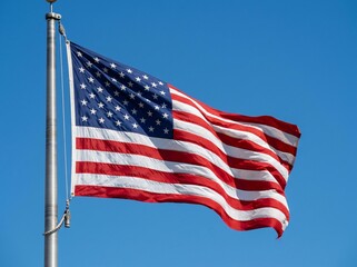 Fototapeta premium The United States of America flag waving proudly against a bright, clear, blue sky