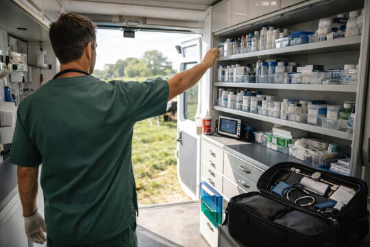 Veterinarian organizing medication in mobile clinic environment