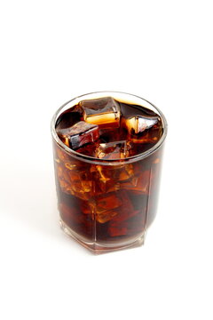  There is a glass with ice and cola on a white background.
