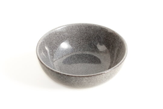 A grey plate stands on a white background.